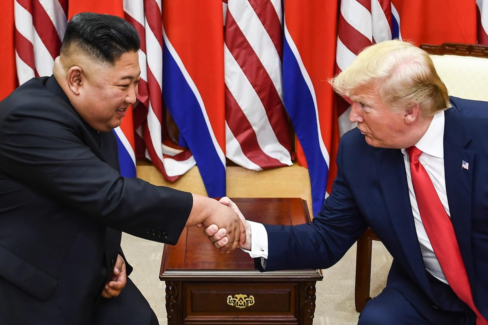 TOPSHOT - North Korea's leader Kim Jong Un (L) and US President Donald Trump shake hands during a meeting on the south side of the Military Demarcation Line that divides North and South Korea, in the Joint Security Area (JSA) of Panmunjom in the Demilitarized zone (DMZ) on June 30, 2019. (Photo by Brendan Smialowski / AFP) (Photo credit should read BRENDAN SMIALOWSKI/AFP via Getty Images)